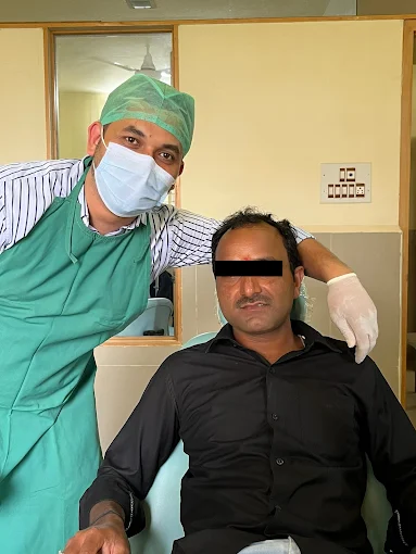 Dr. Wasim Mumtaz treating a patient at Smile World Dental Clinic